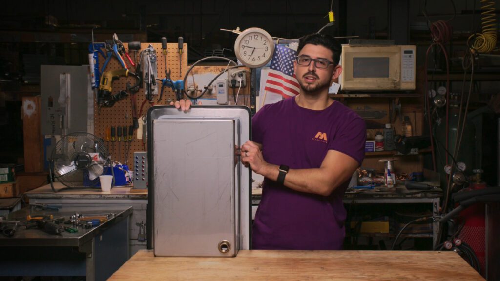 Team member showing a piece of handcrafted foodservice equipment