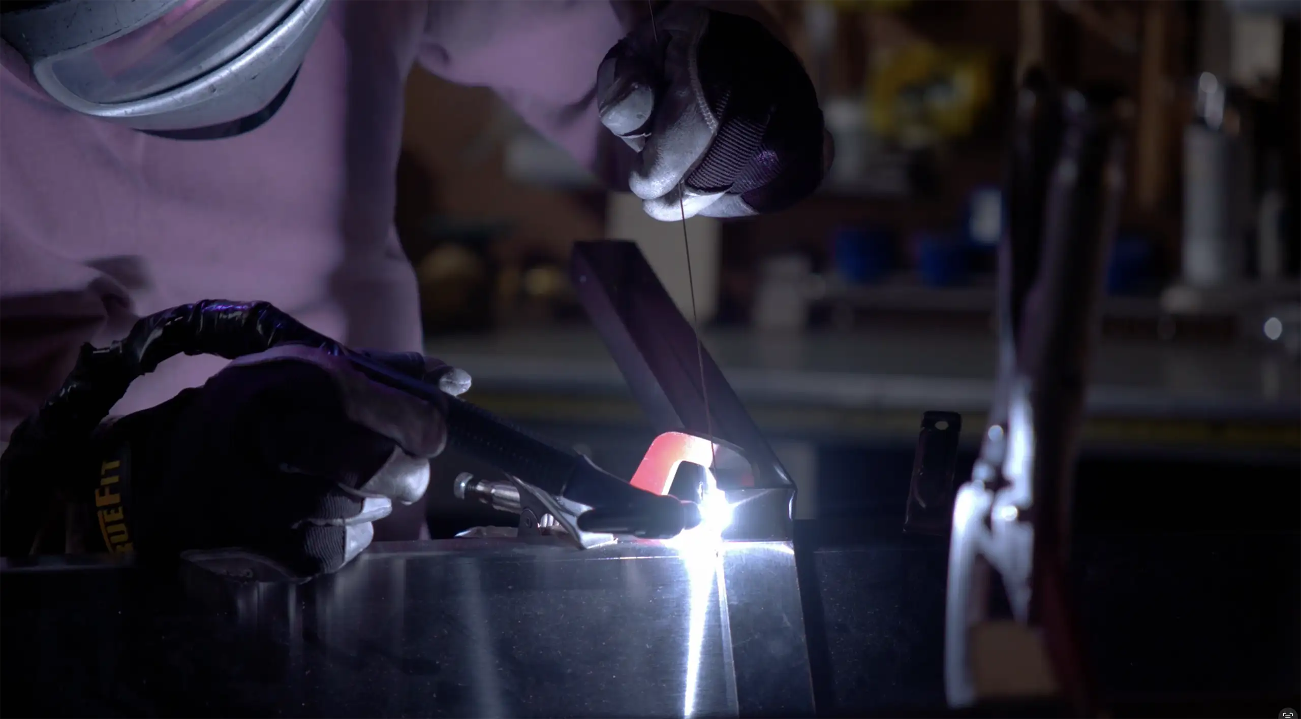 Close-up of a team member welding metal equipment