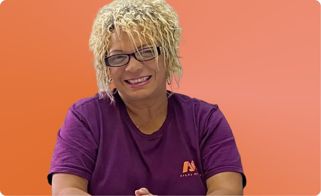 Headshot of Vicky Cabanas with a orange background, Plant II Manager at Atlas Metal