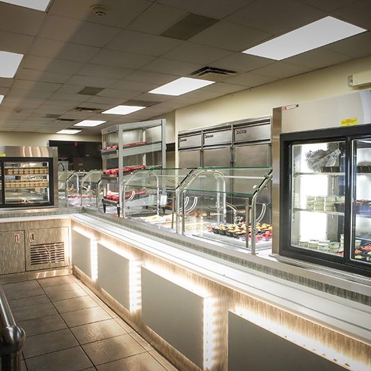 Custom restaurant serving line with refrigerated cases and stainless steel foodservice equipment