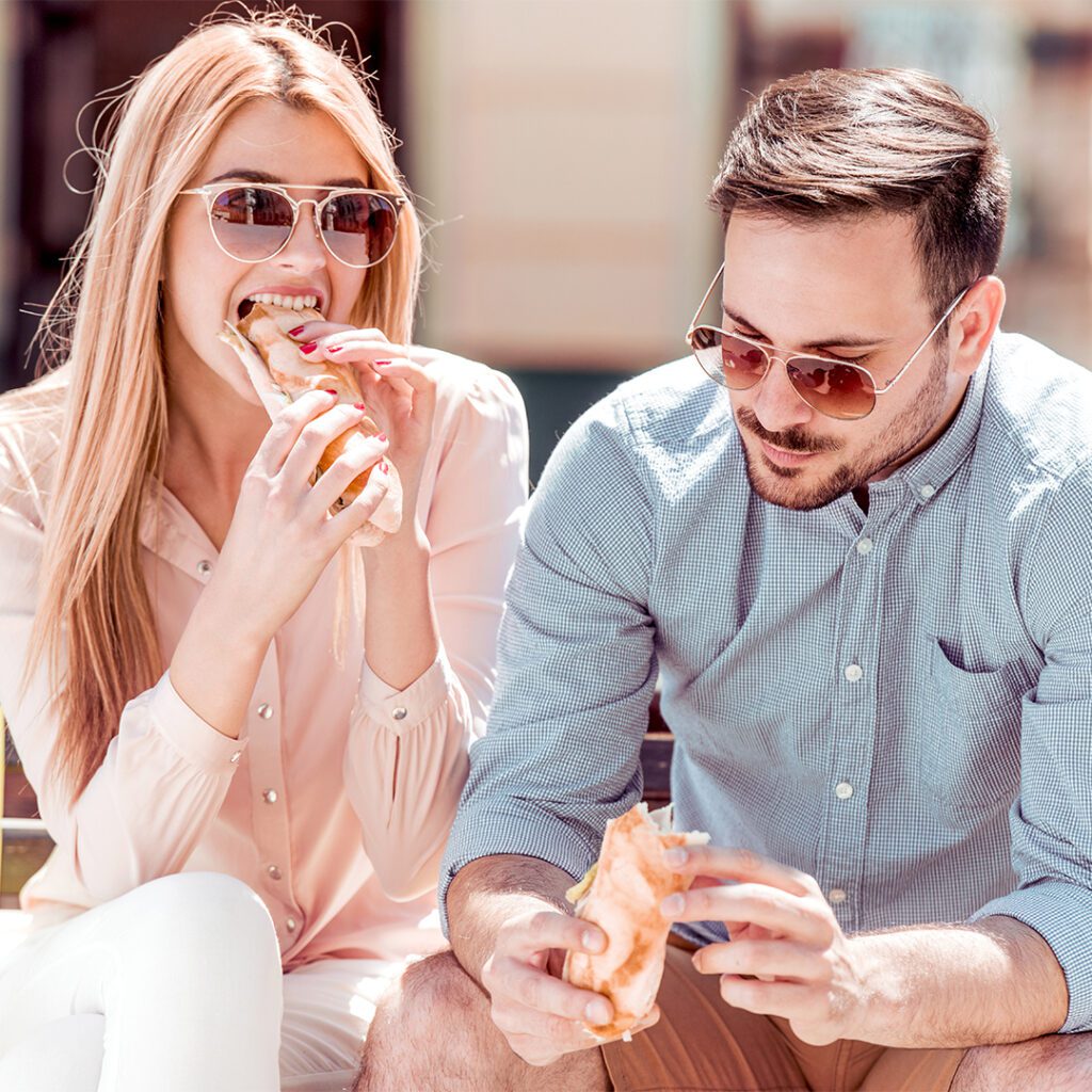 Customers eating outside a convenience store