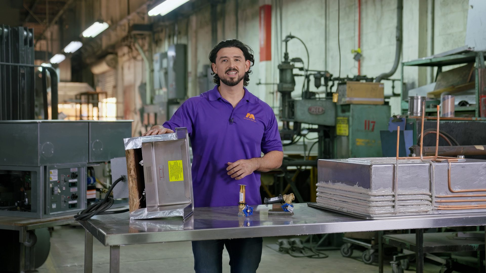 Dominick Mongiove Jr., VP of Operations at Atlas Metal, presenting drop-in unit components in the manufacturing facility
