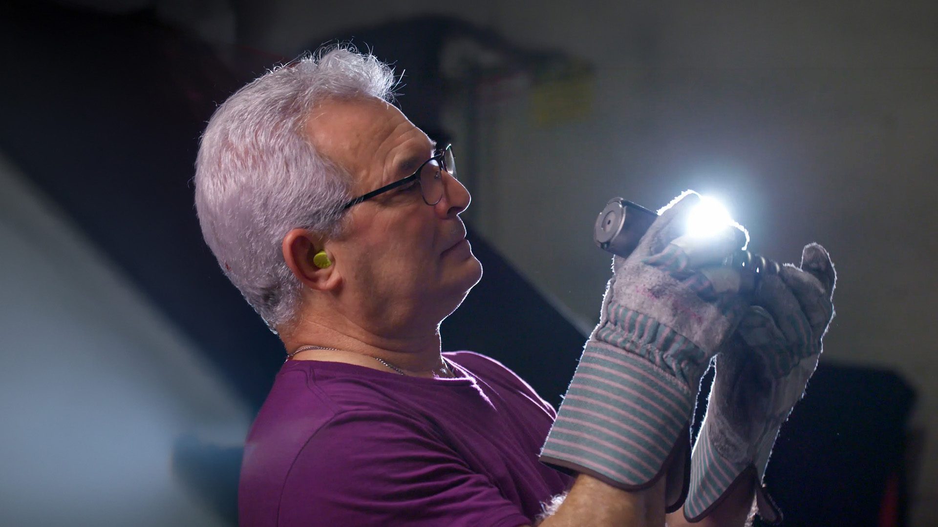 Atlas Metal technician repairing foodservice equipment with a flashlight
