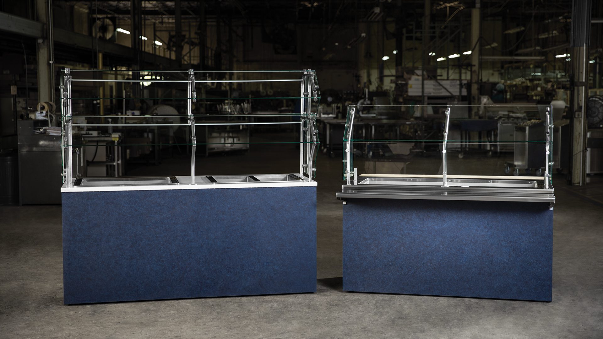Foodservice serving lines with food guards in a manufacturing facility