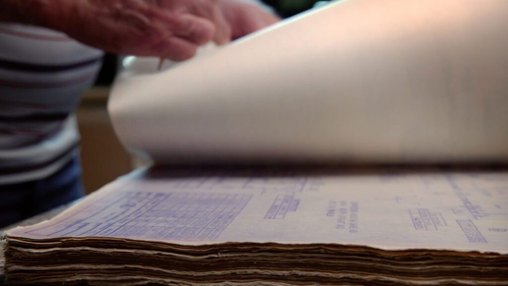 Person reviewing equipment spec sheets and product manuals.